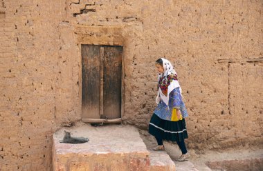 young beautiful Iranian lady in traditional clothing in village of Abyaneh
