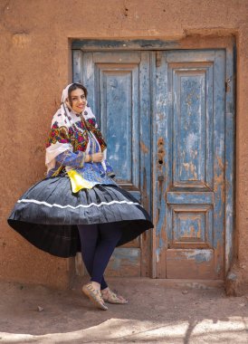 young beautiful Iranian lady in traditional clothing in village of Abyaneh