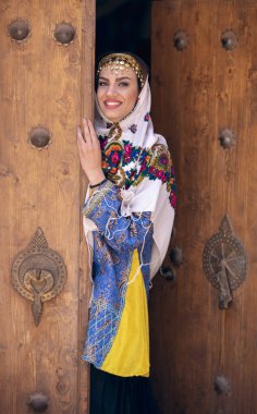 young beautiful Iranian lady in traditional clothing in village of Abyaneh