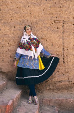 young beautiful Iranian lady in traditional clothing in village of Abyaneh