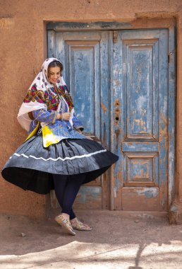 young beautiful Iranian lady in traditional clothing in village of Abyaneh