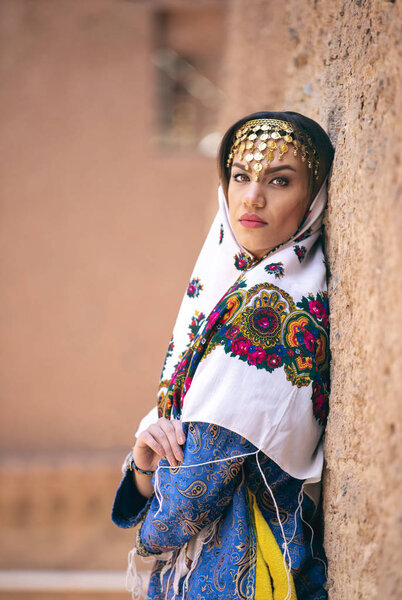 young beautiful Iranian lady in traditional clothing in village of Abyaneh