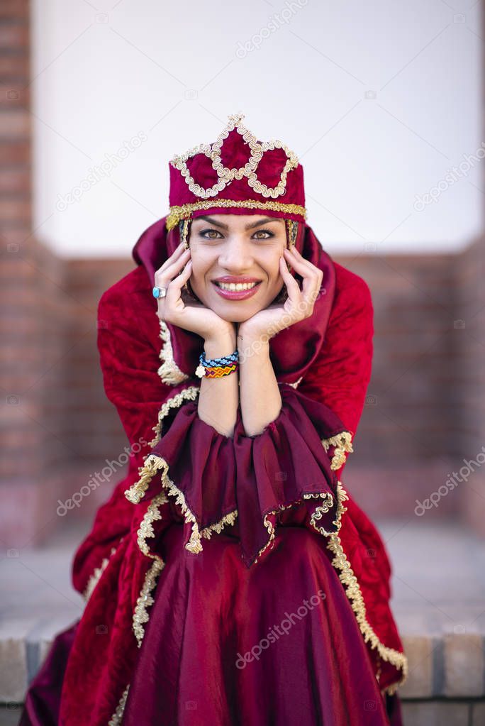 beautiful Iranian lady in traditional outfit smiling for camera