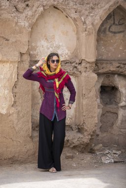 young beautiful Iranian lady on streets of old village in Iran