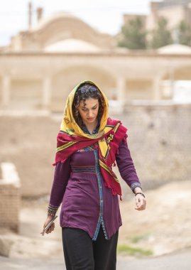 young beautiful Iranian lady on streets of old village in Iran