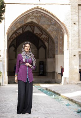 young beautiful iranian lady walking in Fin Gardens in Kashan, Iran