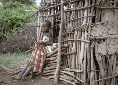 Aynı, Tanzanya - 4 Haziran 2019: Maasai çocuk evlerinden kaçan bebek keçi tutmak