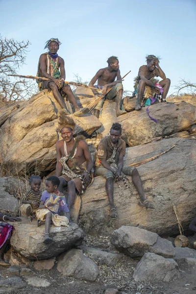 stock image Lake Eyasi, Tanzania, 11th September 2019: Hadzabe men resting on a rock