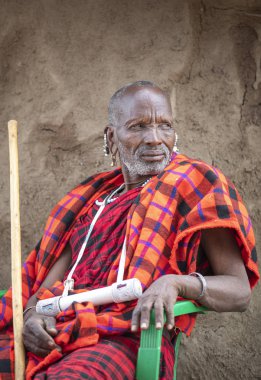 Arusha, Tanzania, 7th September 2019: maasai elder resting outside his home