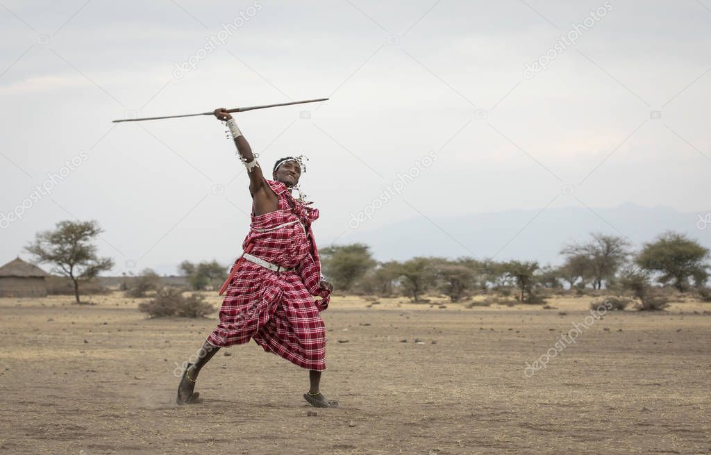 Arusha, Tanzania, 8th September 2019: maasai man throwing a spear