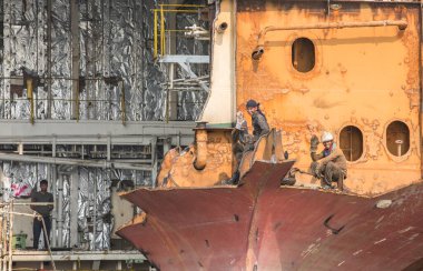 Chittagong, Bangladesh, 24th February 2016: workers at the Chittagong ship breaking yard clipart