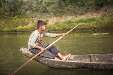 Chittagong, Bangladeş, 25 Şubat 2016: Yedek teknesiyle nehir kenarındaki Bangladeşli çocuk