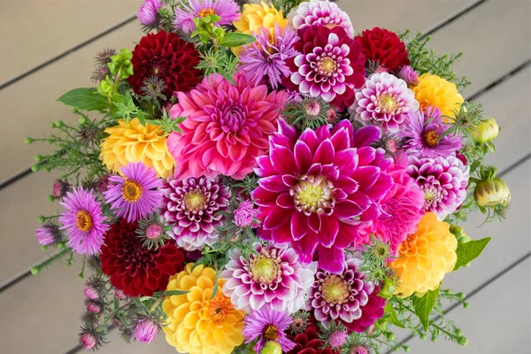 Elegant autumn bouquet or composition of flowers of dahlias, New England asters, red, purple and yellow shades or warm tones. Greeting card with anniversary, teacher\'s day, birthday or Thanksgiving