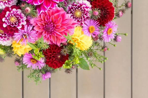 Elegant autumn bouquet or composition of flowers of dahlias, New England asters, red, purple and yellow shades or warm tones. Composition for Thanksgiving, anniversary, teacher\'s day, birthday