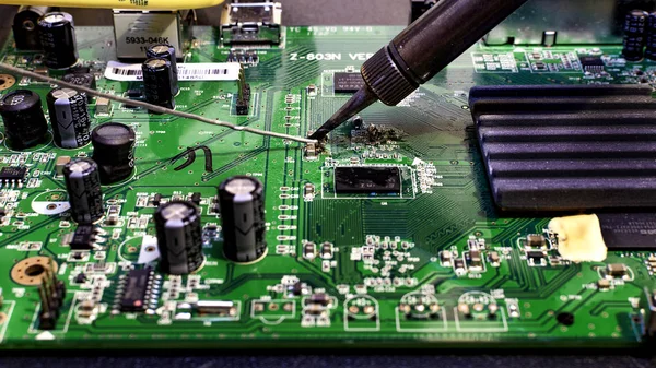 Tin solder on green chip plate with different soldered connectors.