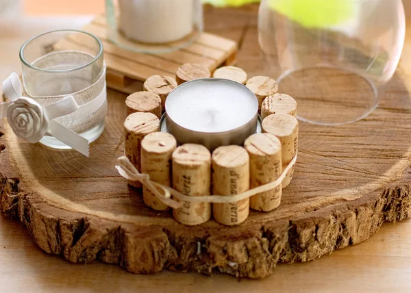 Decoration with wood, white candles and glass elements.