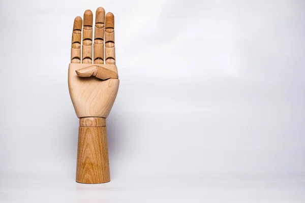 A wooden orthopedic hand on white background.