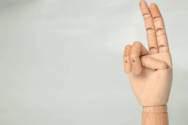 A wooden orthopedic hand on white background.