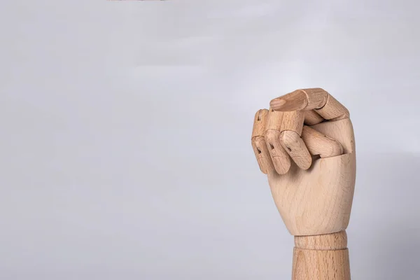 A wooden orthopedic hand on white background.