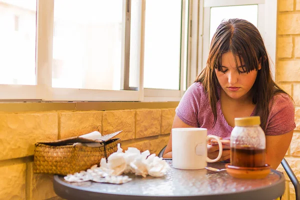 Flu concept. Cold girl with medicines and honey on the table. — Stock Photo, Image