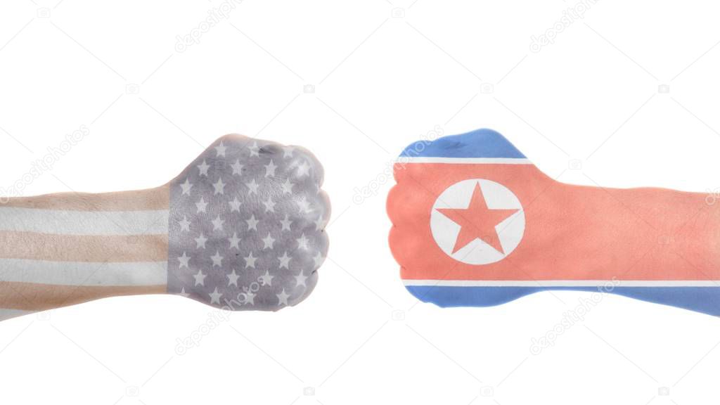 USA and North Korea flags painted on two clenched fists isolated white background