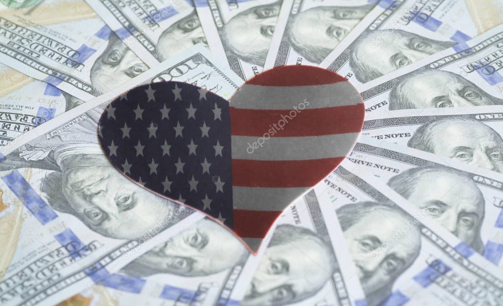 USA flag in form of heart and hundred dollar bills background closeup