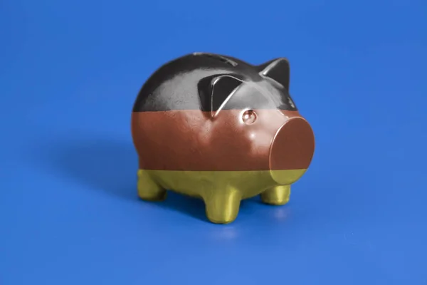 Piggy Bank Com Bandeira Alemã Fundo Azul — Fotografia de Stock