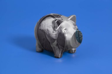 George Washington bir ABD Doları bill mavi zemin üzerine portresi ile Piggy banka.