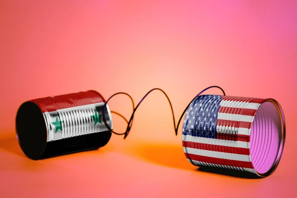 ピンクの米国とシリアの Flags Communication のコンセプトとブリキ缶電話 — ストック写真