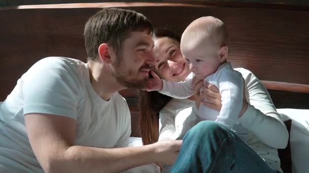 Happy family spending time together in bedtime playing and hugging — Stock Video