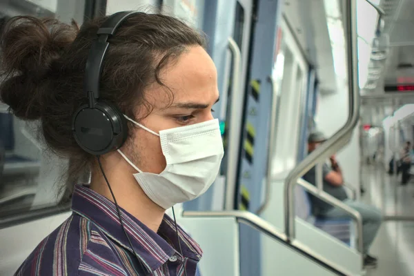 Masked Sad Looking Thoughtful Teenager Listening Music Headphone Subway Socially — Stock Photo, Image