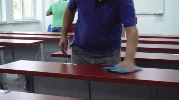 Two School Janitors Cleaning Disinfecting Wooden Desks Empty University Classroom — Stock Video
