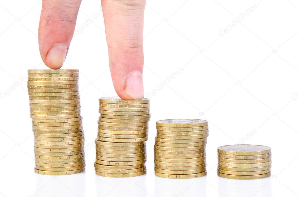 fingers step on a stack of coins. Business growth chart.