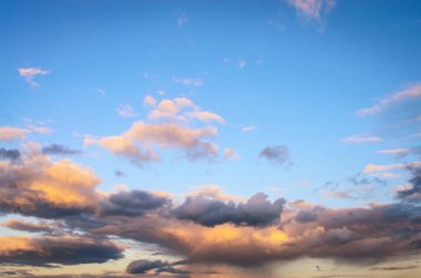 Sarı bulutlu güzel gökyüzü gün batımında altın ışıkla aydınlandı.