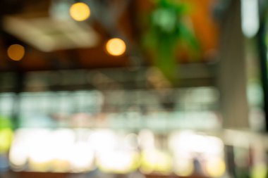 Bulanık kafe ve restoran arka planında rahat atmosfer, sehpa sehpaları ve doğal ışık var. Uzaktan çalışma, yaratıcı tasarım, yaşam tarzı modellemeleri ve sunum arkaplanı için mükemmel.