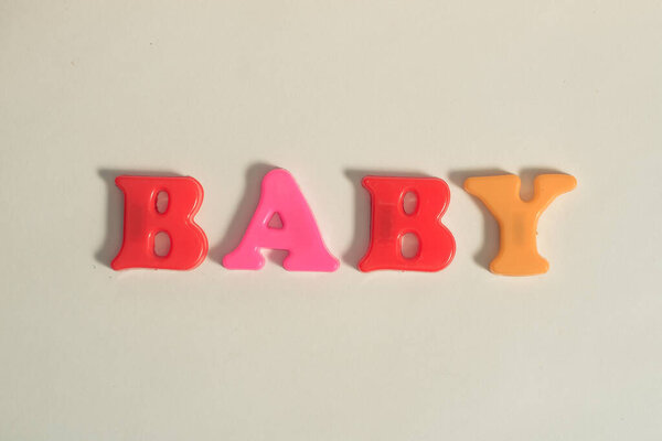 plastic letters message baby on white isolated background