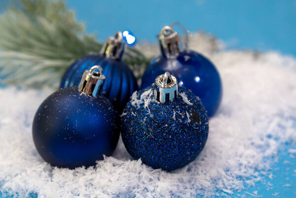 blue christmas balls on the snow