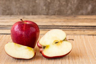 Eski ahşap masa arka plan üzerinde yarım taze elma dilim