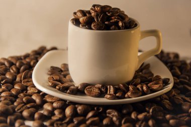 Güzel kokulu kavrulmuş kahve çekirdekleri kahverengi ve Kupası