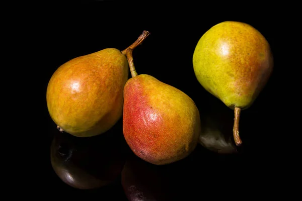 Three ripe pears on a black background — Stock Photo, Image