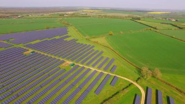 İngiltere 'nin Northamptonshire kentindeki bir güneş çiftliğindeki büyük güneş paneli dizilerinin hava görüntüsü.