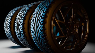 Stüdyonun ışıklandırmasında arka planda yan yana dizilmiş altın alaşımlı jantlar ve derin lastikler ile şık siyah araba lastiklerine yakın bir perspektif..