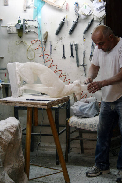 At Volterra - Italy - On 01/08/2018 - sculptor at work in his workshop