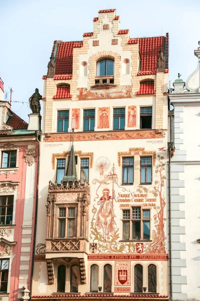 painted baroque facade of a palace in the old square of Prague, Czech republic