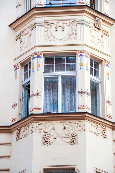 decorated bow-window on the baroque facade of an old palace in the old square of Prague, Czech republic