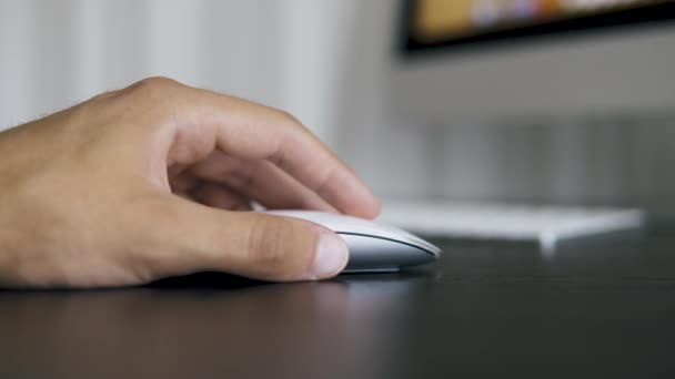 Man working in office and clicking on white computer mouse — Stock Video