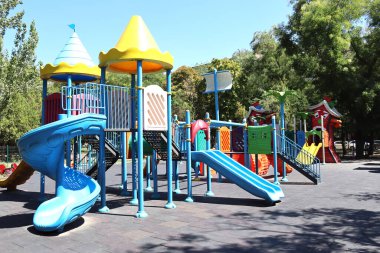 Outdoor colorful playground with slides, towers and safety flooring in a city park; for stories on urban design, recreation and public space. 29 August 2025, Ankara, Turkey. Editorial use only.