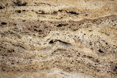 High-resolution travertine stone texture with porous layers and organic patterns; perfect for backgrounds, product mockups, architectural design, and material presentations.