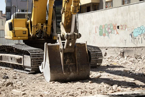 03 September 2025, Ankara, Turkey  Yellow crawler excavator on rubble at an urban demolition site beside residential buildings; editorial use for news, construction, infrastructure, redevelopment