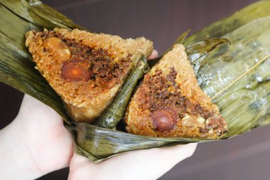 Duanwu ya da Zongzi Festivali olarak da bilinen Ejderha Botu Festivali 'nin kutlaması için el ele tutuşan Zongzi (Yapışkan pirinç köftesi veya Bacang)..